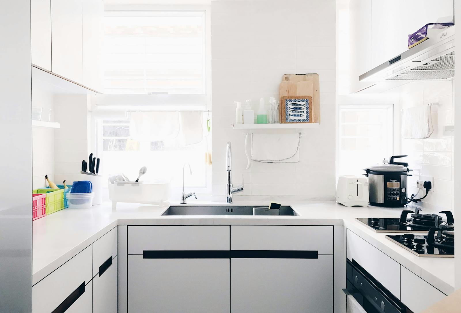 Minimalist white kitchen counter with a clean modern surface, representing the hidden look of invisible induction cooktops.