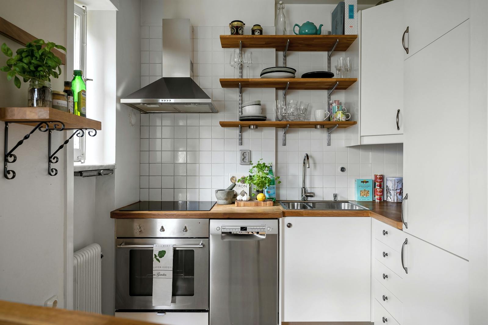 Bright kitchen with white cabinets and silver appliances, representing simple daily upgrades that improve how the kitchen works.