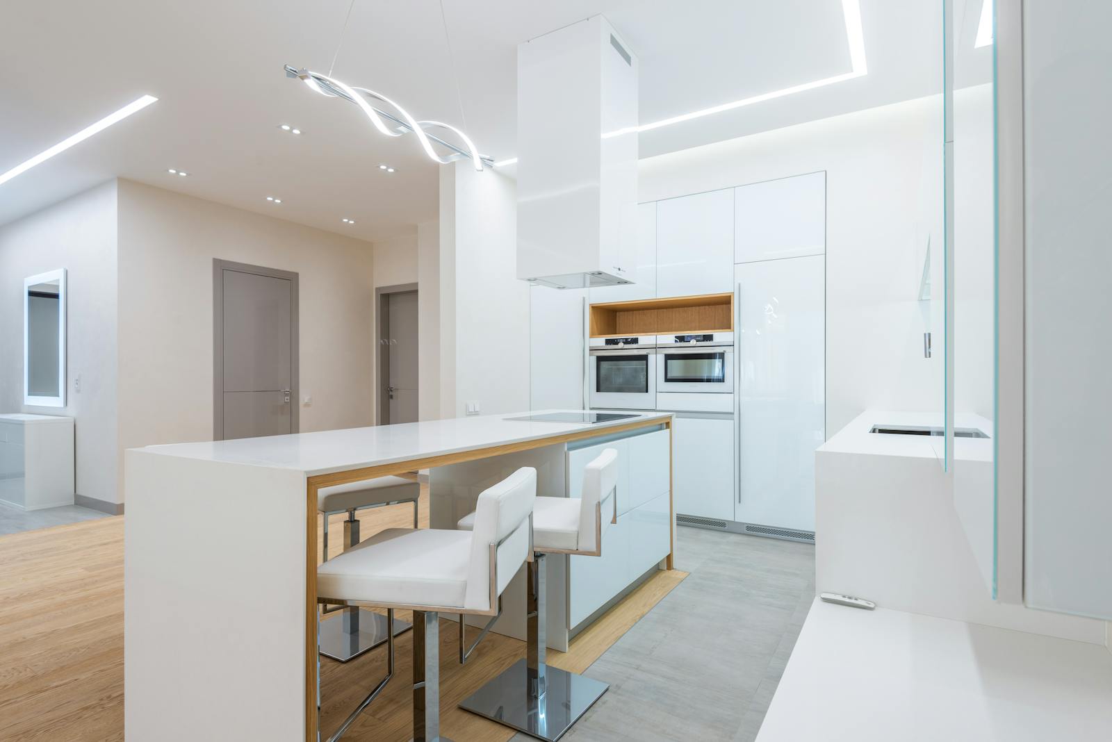 Contemporary light kitchen with a stylish and organized interior, representing modern multi-zone kitchen design.