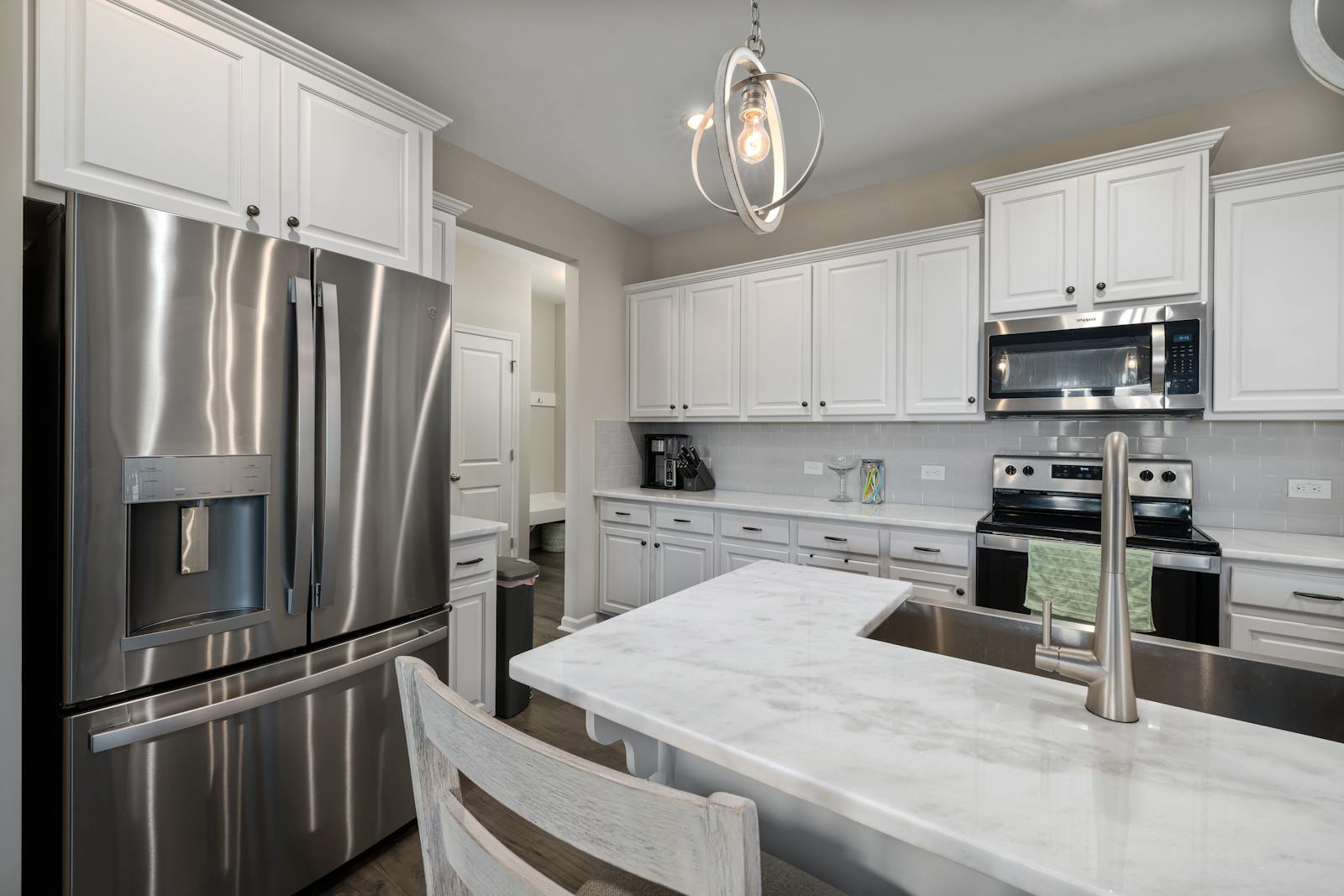 Bright interior kitchen design with clean counters and organized surfaces, representing the kind of small daily habit that prevents mess from building up.