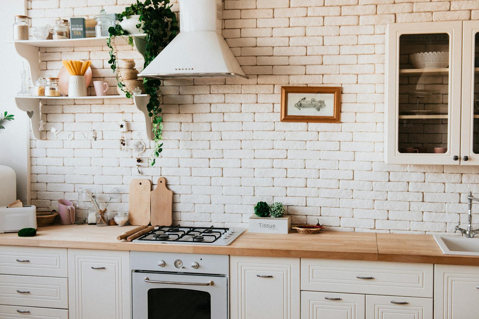 Bright white kitchen with cabinetry and counters, representing smarter hidden storage in a compact kitchen.