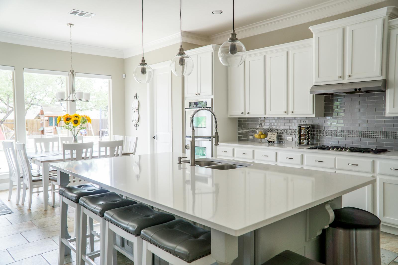 Bright full kitchen interior with counters and cabinetry, representing a modern kitchen where a breakfast station fits naturally into the layout.