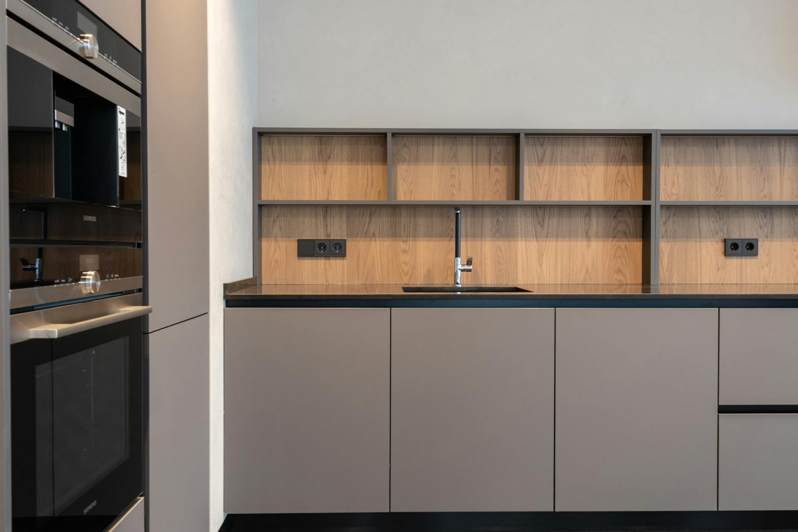 Modern kitchen with clean cabinetry and minimal open display, representing the shift away from open shelving toward calmer storage.
